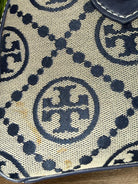 Close-up of a patterned fabric with a logo, likely from a brand.